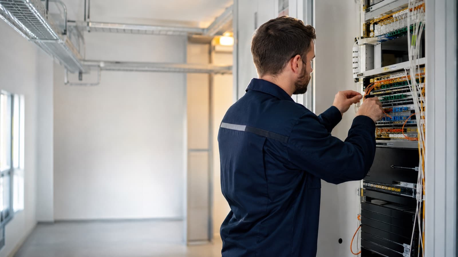 Telecommunications engineer working on fibre connectivity infrastructure